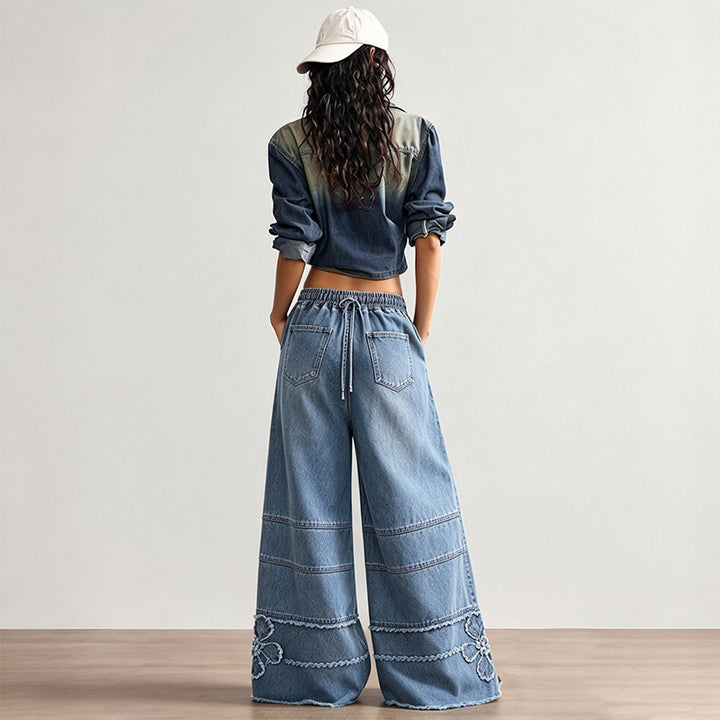 High-street style, high-waisted, embroidered floor-length jeans—a trendy piece