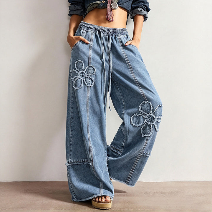 High-street style, high-waisted, embroidered floor-length jeans—a trendy piece