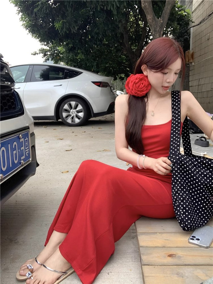 An elegant, fitted, backless dress; a long, form-fitting skirt.