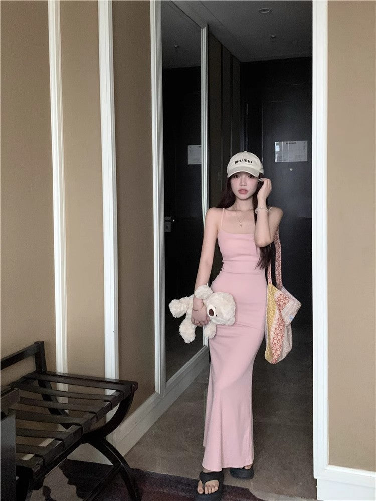 An elegant, fitted, backless dress; a long, form-fitting skirt.