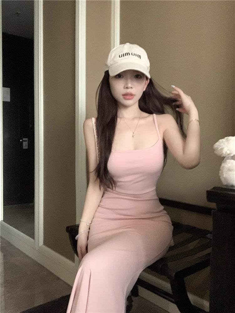 An elegant, fitted, backless dress; a long, form-fitting skirt.
