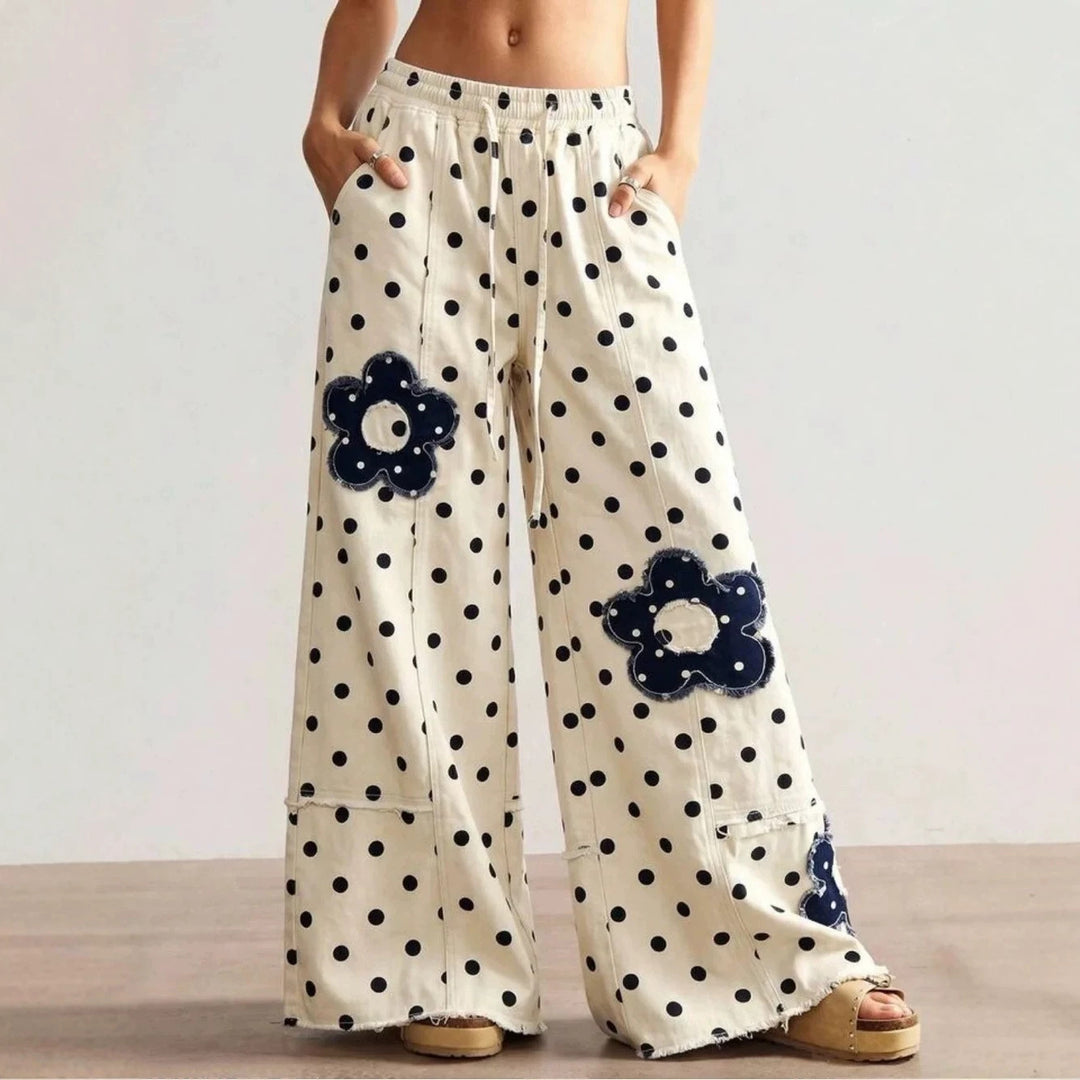 High-street style, high-waisted, embroidered floor-length jeans—a trendy piece