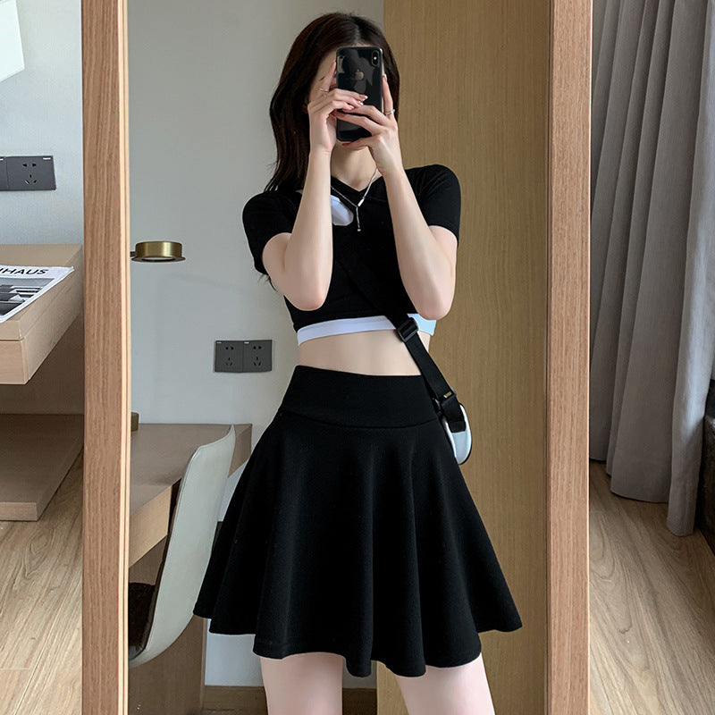 The new pleated skirt is paired with a loose white shirt featuring a tie-back detail.