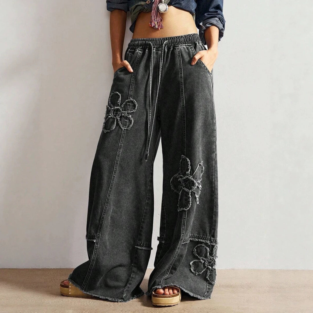 High-street style, high-waisted, embroidered floor-length jeans—a trendy piece