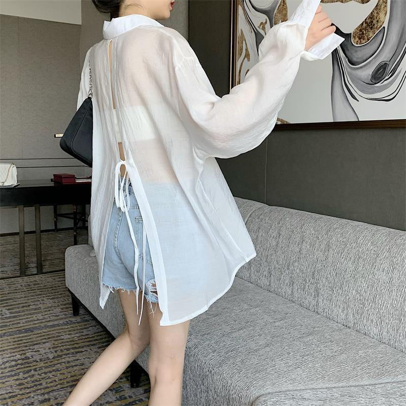 The new pleated skirt is paired with a loose white shirt featuring a tie-back detail.