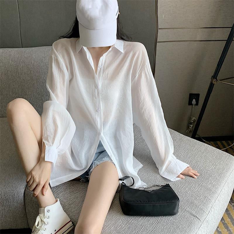 The new pleated skirt is paired with a loose white shirt featuring a tie-back detail.